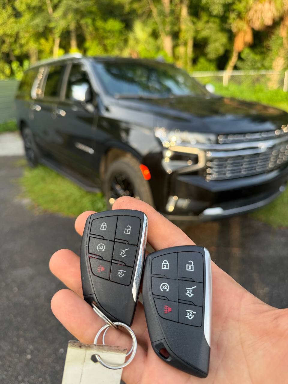Programmed vehicle keys in front of a Chevrolet SUV